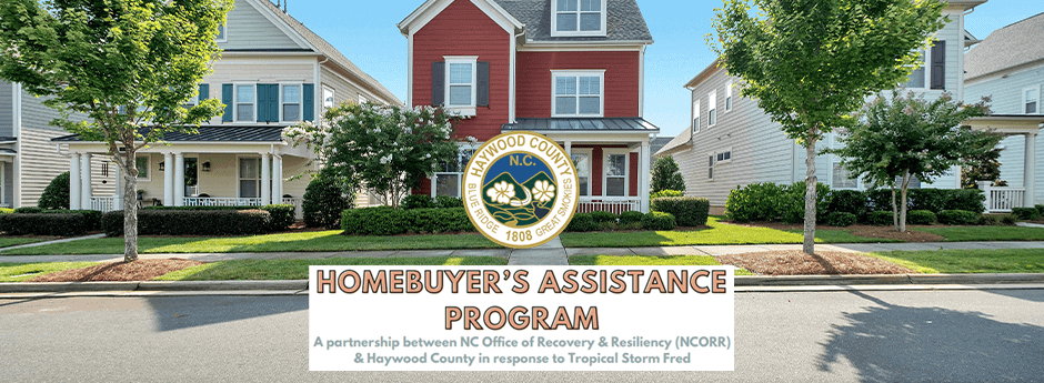 A row of suburban houses with a Haywood County seal and text: Homebuyers Assistance Program—A partnership between NCORR & Haywood County in response to Tropical Storm Fred.