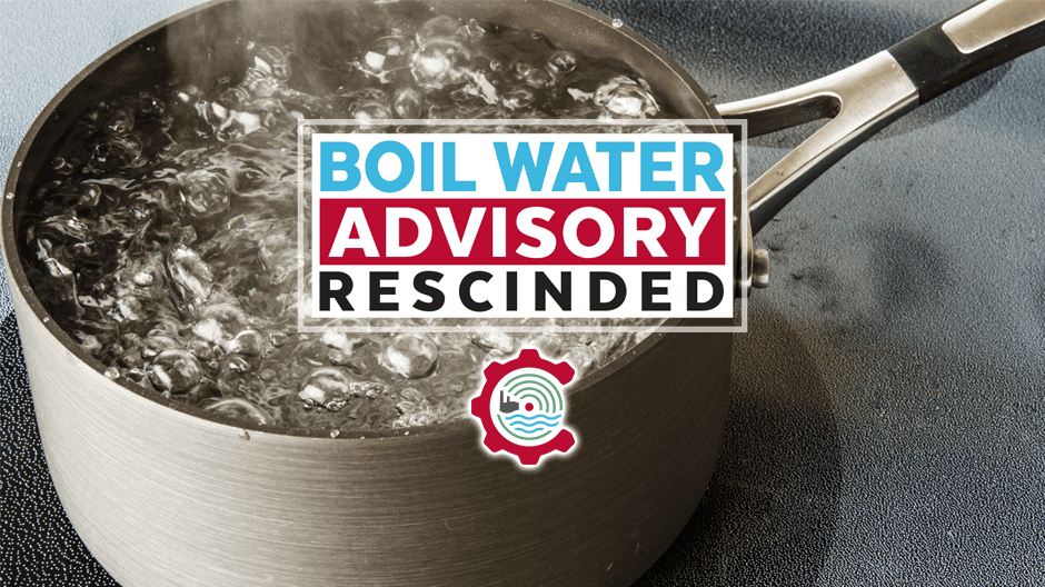 A pot of water boiling on a stovetop with a sign overlay that reads, Boil Water Advisory Rescinded, indicating the advisory has been lifted.