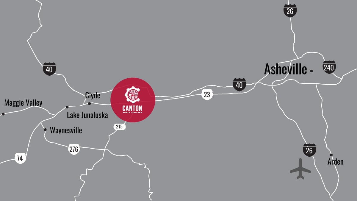 Map showing Asheville and Canton, North Carolina, with major highways (I-26, I-40), towns (Waynesville, Clyde, Maggie Valley), and a red circle highlighting Canton. An airplane icon denotes an airport near Arden.