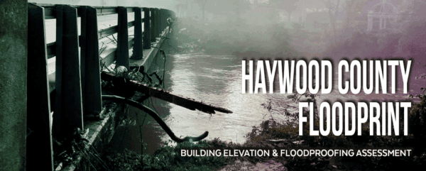 A damaged bridge over a flooded river with debris piled against the railing. Text reads: Haywood County Floodprint. Building elevation & floodproofing assessment.
