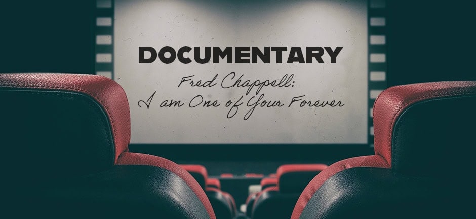 A movie theater with red seats faces a screen displaying the text: DOCUMENTARY Fred Chappell: I am One of Your Forever.