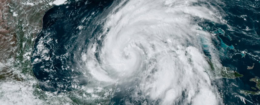Satellite image showing a large, swirling hurricane over the Gulf of Mexico, with dense clouds covering parts of the Yucatán Peninsula, Cuba, and surrounding waters.