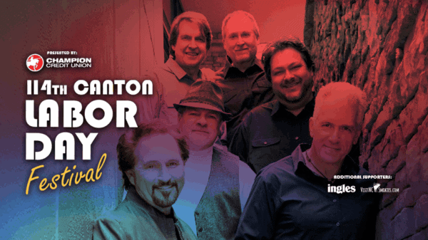 Six men stand smiling beside a stone wall. The text reads: 114th Canton Labor Day Festival, with sponsor logos for Champion Credit Union, Ingles, Young & McQueen, and Smoky Mountain News.