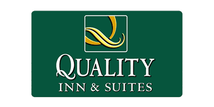 Green logo with a yellow ribbon design above the words Quality Inn & Suites in white text.