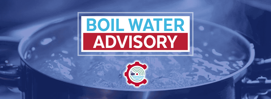A large pot of boiling water with a sign that reads Boil Water Advisory in bold letters, and a water-related logo underneath.