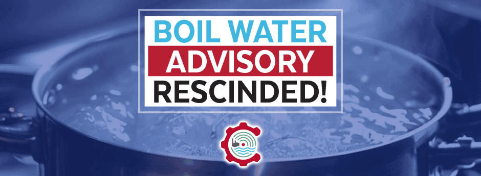 A pot of boiling water with a sign stating Boil Water Advisory Rescinded! in bold blue, red, and black letters, and a water-related logo below the text.