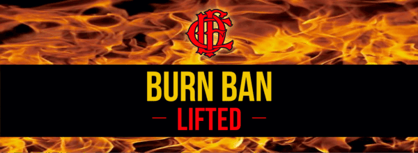 Flames in the background with a red fire department logo above bold yellow text reading BURN BAN and red text below reading LIFTED.